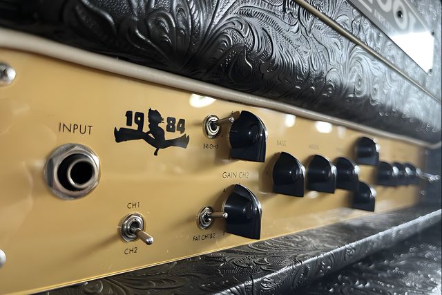 Close-up of the controls of a Kool 1984 with black knobs and the 1984 emblem